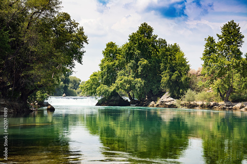 Landscape with forest and a river in front. Beautiful scenery.