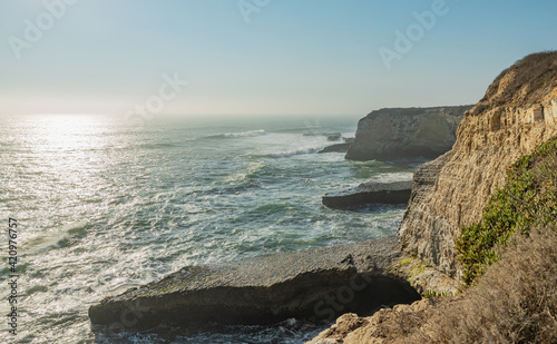 Beautiful seascape of the Pacific coast in California, waves, rocks, sky, sun. Concept, perfect postcard and guide.