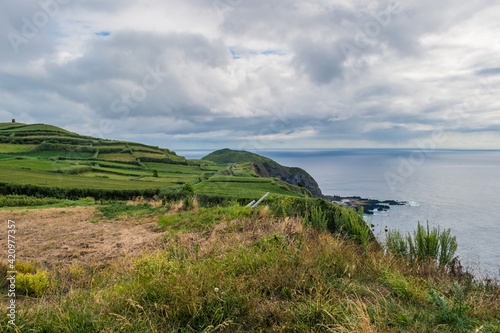 Green fields of cultivation on cliffs next to the Atlantic Ocean in Ponta da Ferraria, São Miguel - Azores PORTUGAL
