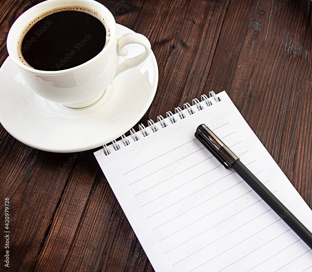 coffee and notepad on wooden background coffee and notepad on wooden background