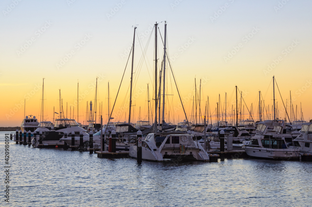 Sunset over the Hillarys marina full of mooring boats - Perth, WA, Australia