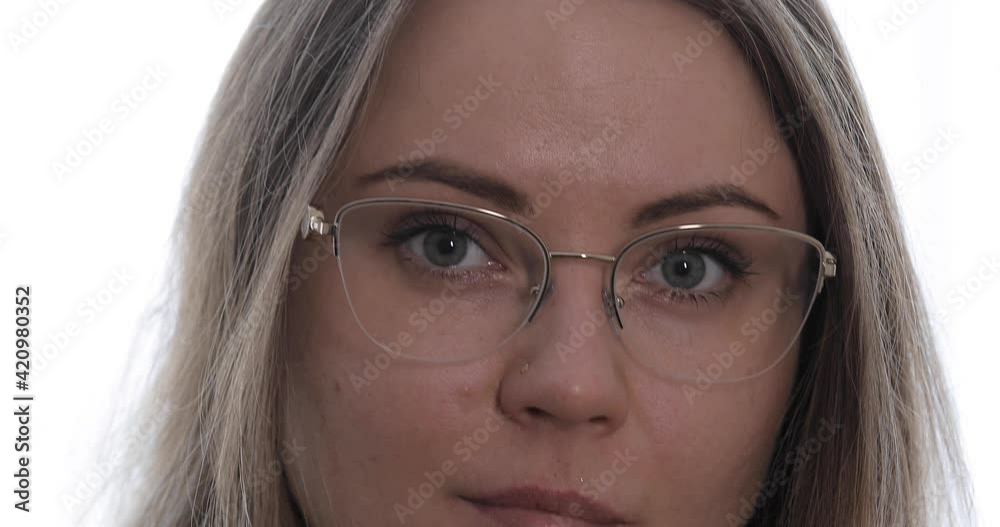 Young beautiful girl trying on new fashionable glasses. Close-up Young beautiful girl trying on new fashionable glasses. Close-up