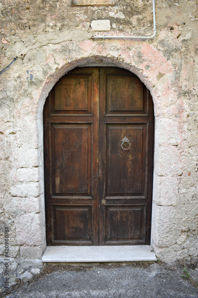Brawn wooden door on stone house