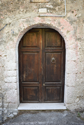Brawn wooden door on stone house