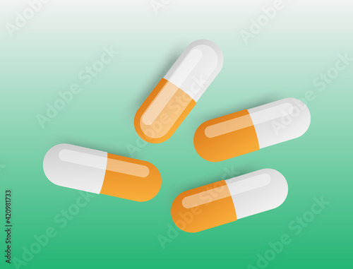 The capsules are scattered on a green background
