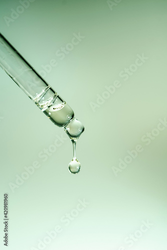 A drop of cosmetic oil falls from the pipette © Marevgenna