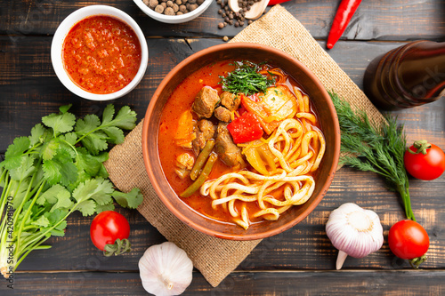 Lagman soup from middle Asia on dark wooden background