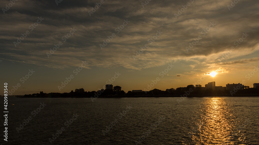 Naklejka premium Sunset over the Scheldt river, in Antwerp, Belgium