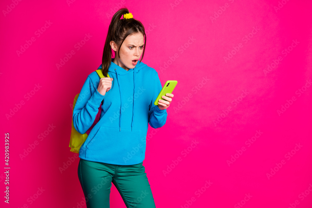 Photo of sad shocked lady wear blue sweater rucksack chatting modern device empty space isolated bright pink color background Photo of sad shocked lady wear blue sweater rucksack chatting modern device empty space isolated bright pink color background