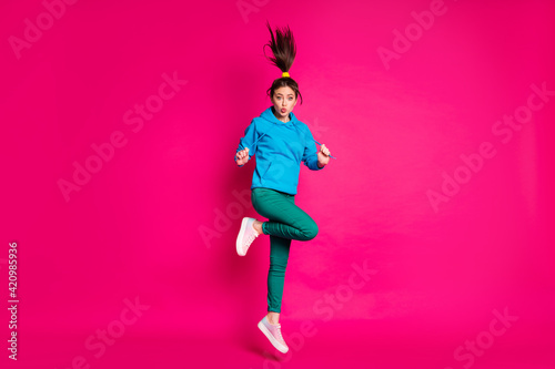 Full size photo of young cute pretty lovely attractive beautiful girl jumping and pout lips isolated on pink color background