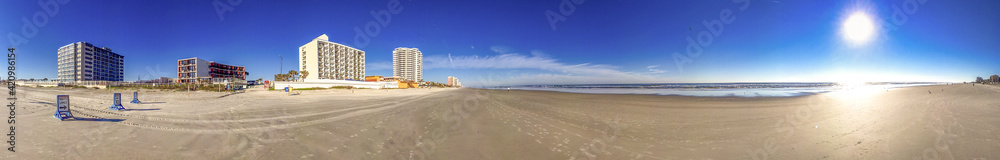 Empty beach of Daytona Beach on a beautiful sunny winter day, Florida - Panoramic view Empty beach of Daytona Beach on a beautiful sunny winter day, Florida - Panoramic view
