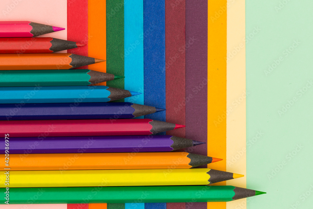 Many multicoloured pencils on colourful background Many multicoloured pencils on colourful background