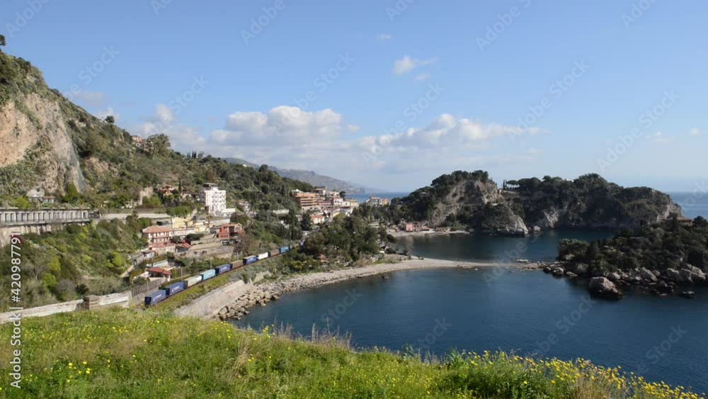 freight wagons pass in front of Isola Bella Taormina Sicily freight wagons pass in front of Isola Bella Taormina Sicily