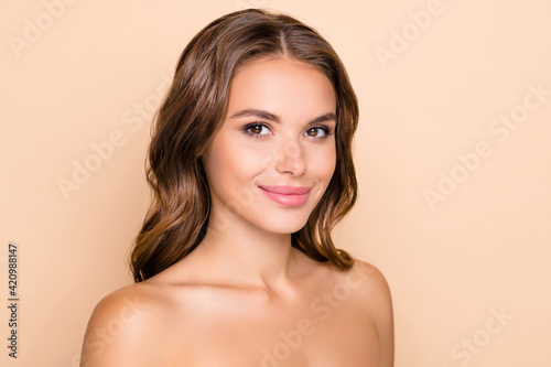 Photo of nice optimistic lady without clothes look to camera isolated on pastel beige color background