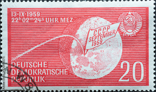  the Earth moon with stylized trajectory of Lunik 2, impact date and USSR national coat of arms. Reaching the surface of the moon by Lunik 2