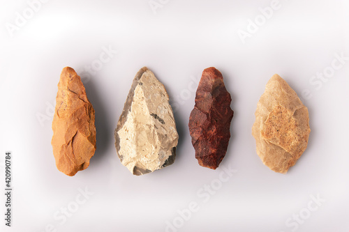 four prehistoric quartzite spearheads. From the Atherian lithic industry. From the Paleolithic and Acheulean culture, from the Sahara desert. On white background