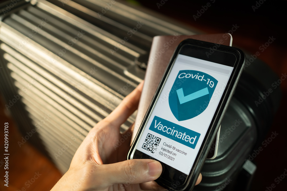 Covid-19 vaccine passport concept. Vaccinated people holding the phone with vaccine certificate while traveling. Covid-19 vaccine passport concept. Vaccinated people holding the phone with vaccine certificate while traveling.