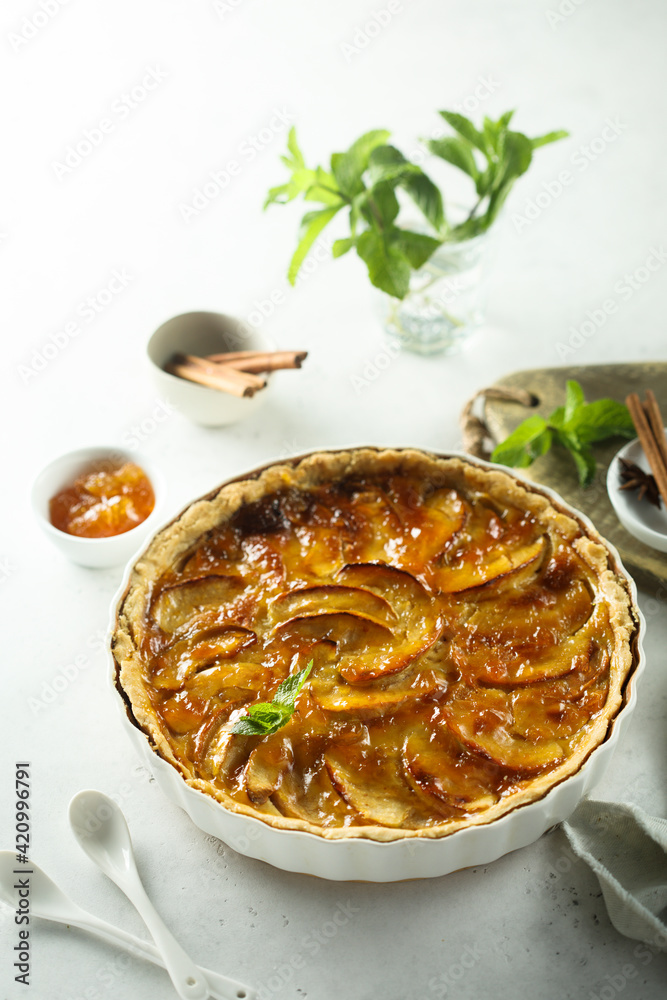 Traditional homemade apple tart with apricot jam