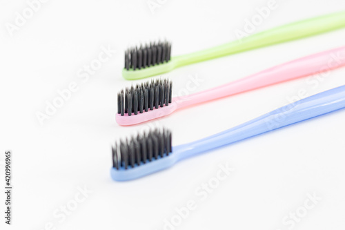 Colorful toothbrushes on a white background. Close-up. Soft Focus