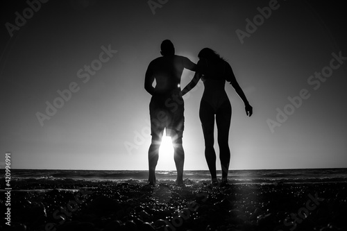 Beautiful young couple on the beach. Honeymoon. Sunset