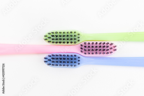 Colorful toothbrushes on a white background. Close-up. Soft Focus