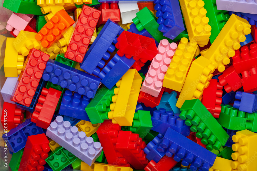 A pile of multicolored childrens designer with large bricks A pile of multicolored childrens designer with large bricks