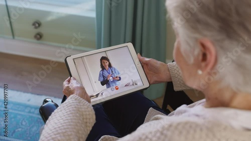 Senior woman in tele medicine video call with doctor