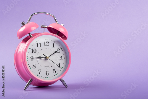 Wallpaper Mural A table clock with a Purple background flat lay shot. Torontodigital.ca