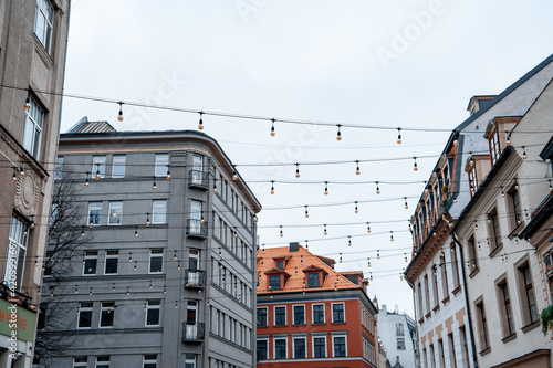City street lights on a wire stretched between houses. Beautiful cityscape (470)