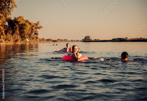 Friends enjoying a summer day swimming at the lake. © Zoran Zeremski
