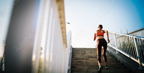 Happy young woman exercising outdoors. Living healthy life