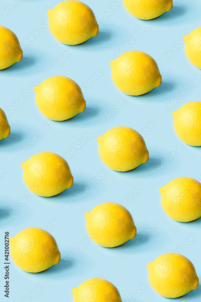 Pattern of ripe lemons on a blue background. Summer concept. Pattern of ripe lemons on a blue background. Summer concept.