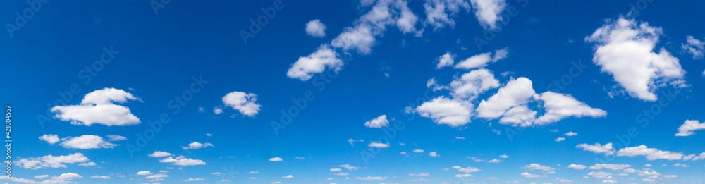 Panoramic fluffy cloud in the blue sky. Sky with cloud on a sunny day. Panoramic fluffy cloud in the blue sky. Sky with cloud on a sunny day.