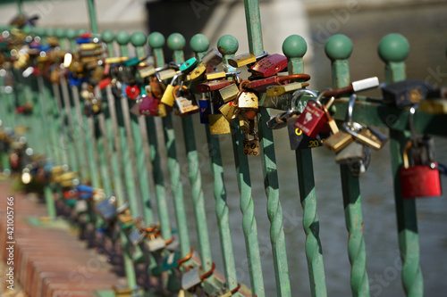 Love locks near Steel pedestrian Tumski Bridge across Oder River, popular tourist landmark