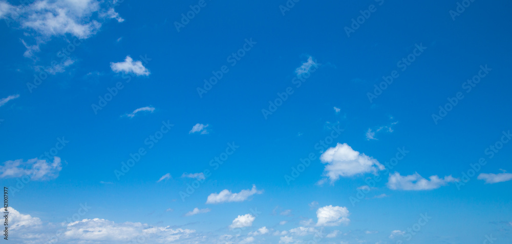 blue sky background with tiny clouds