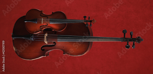 cello and violin on a red background