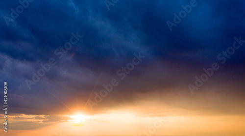 Sunset with sun rays, sky with clouds and sun. © Pakhnyushchyy