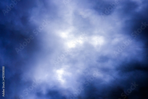 Blurred abstract Dramatic blue sky with white clouds background.Toned,soft focus.