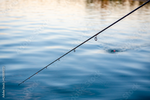 Fotografiet fishing rod and river, close up