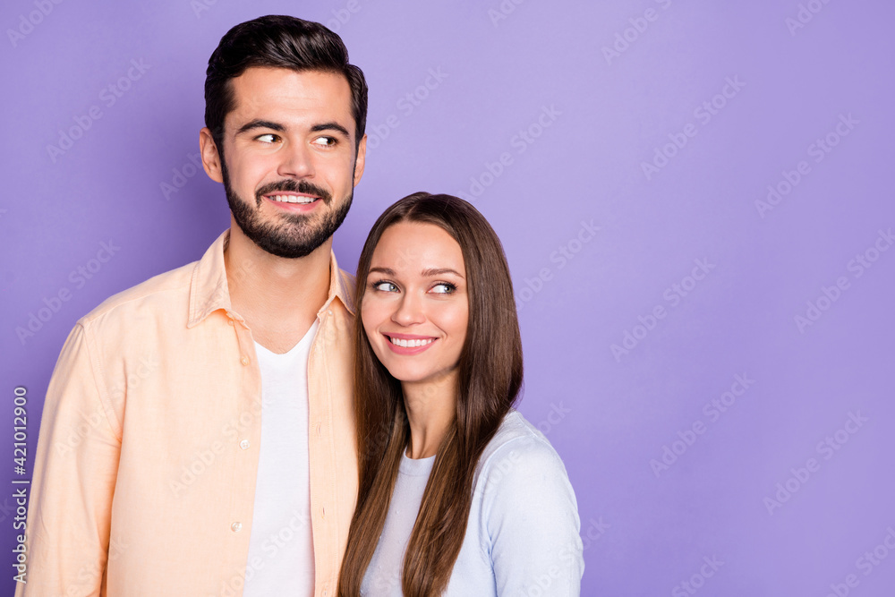 Photo of happy lovely spouses look empty space information idea good mood isolated on violet color background Photo of happy lovely spouses look empty space information idea good mood isolated on violet color background