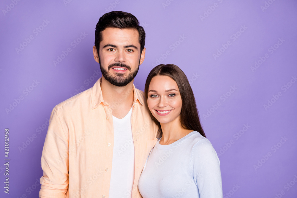 Portrait of two satisfied persons standing close toothy smile look camera isolated on purple color background Portrait of two satisfied persons standing close toothy smile look camera isolated on purple color background