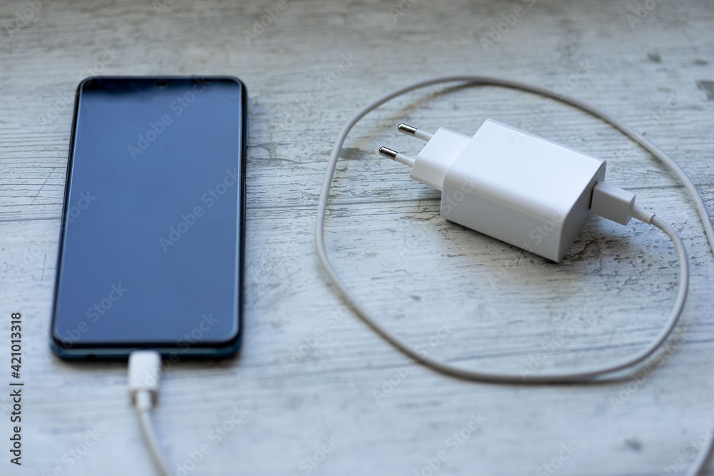 smartphone charger with power bank on white wood smartphone charger with power bank on white wood