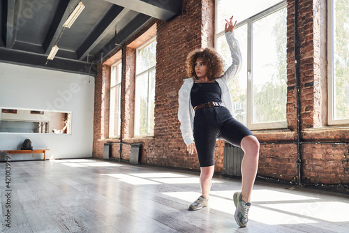 Graceful young woman dancing in sport studio