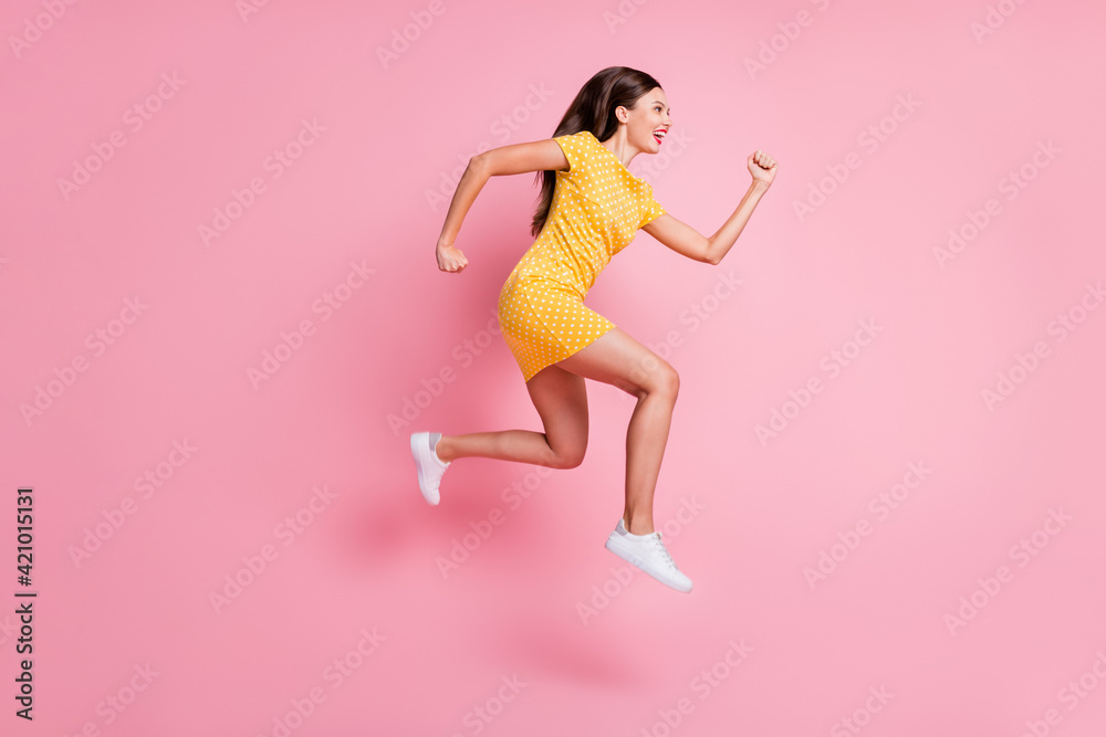 Full size profile side photo of charming cheerful trendy young woman jump up run copyspace isolated on pink color background