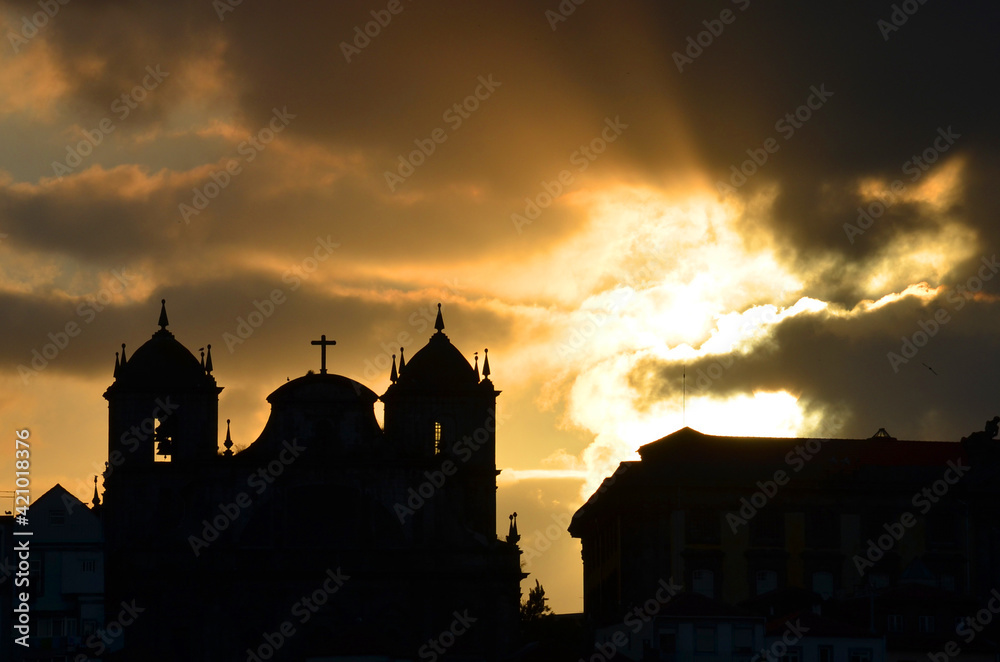 the silhouette of the church on the background of a beautiful sunset in Portugal. The concept of faith and religion