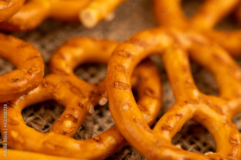 Salted breadsticks and salted pretzels scattered on the table. Salted breadsticks and salted pretzels scattered on the table.