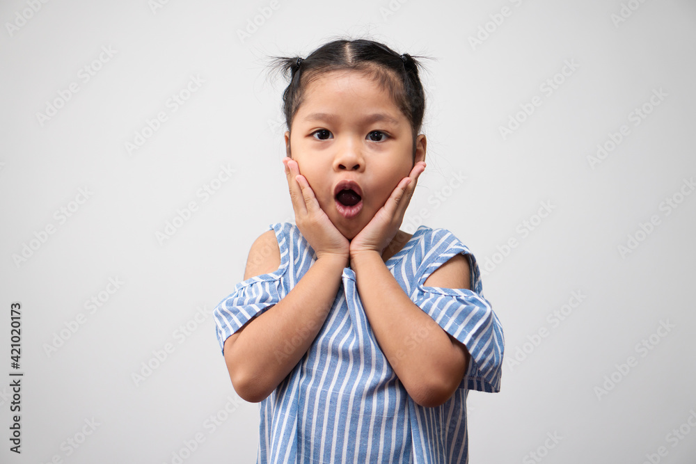 Portrait of Asian child and to collect hair and Put here hands on the cheeks and excited pose on isolated white background, She is Happiness, radiance in youth, Education Concept Portrait of Asian child and to collect hair and Put here hands on the cheeks and excited pose on isolated white background, She is Happiness, radiance in youth, Education Concept