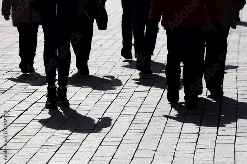 Bild auf Leinwand Silhouettes and shadows of people walking on the city street