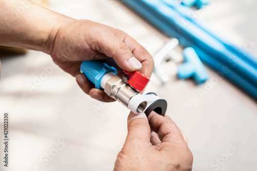 Vászonkép plumber putting teflon thread tape on the thread , Preparing to connect to PVC P