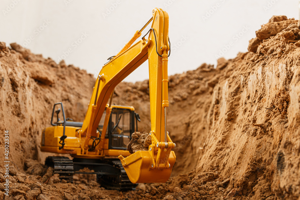 Selective focus ,bucket of excavators are digging the soil in the construction site with on white background Selective focus ,bucket of excavators are digging the soil in the construction site with on white background